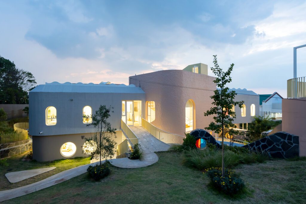 Evening view of Redhill Early Learning Centre with beautiful lighting and the garden for play