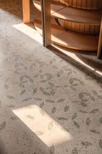 Flooring detail of the fallen leaf pattern in green glass chips at FoK Library, Mumbai by Studio Hinge