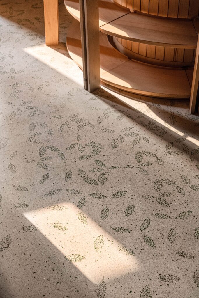 Flooring detail of the fallen leaf pattern in green glass chips at FoK Library, Mumbai by Studio Hinge