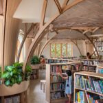 Browsing in hedges, with the corner workspace in background at FoK library, Mumbai by Studio Hinge