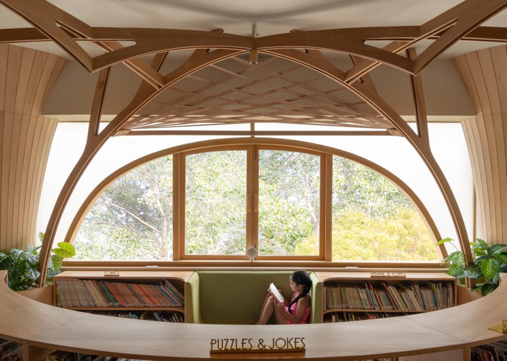 Built-in benches below windows offer informal seating at FoK Library, Mumbai by Studio Hinge