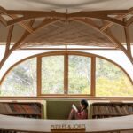 Built-in benches below windows offer informal seating at FoK Library, Mumbai by Studio Hinge