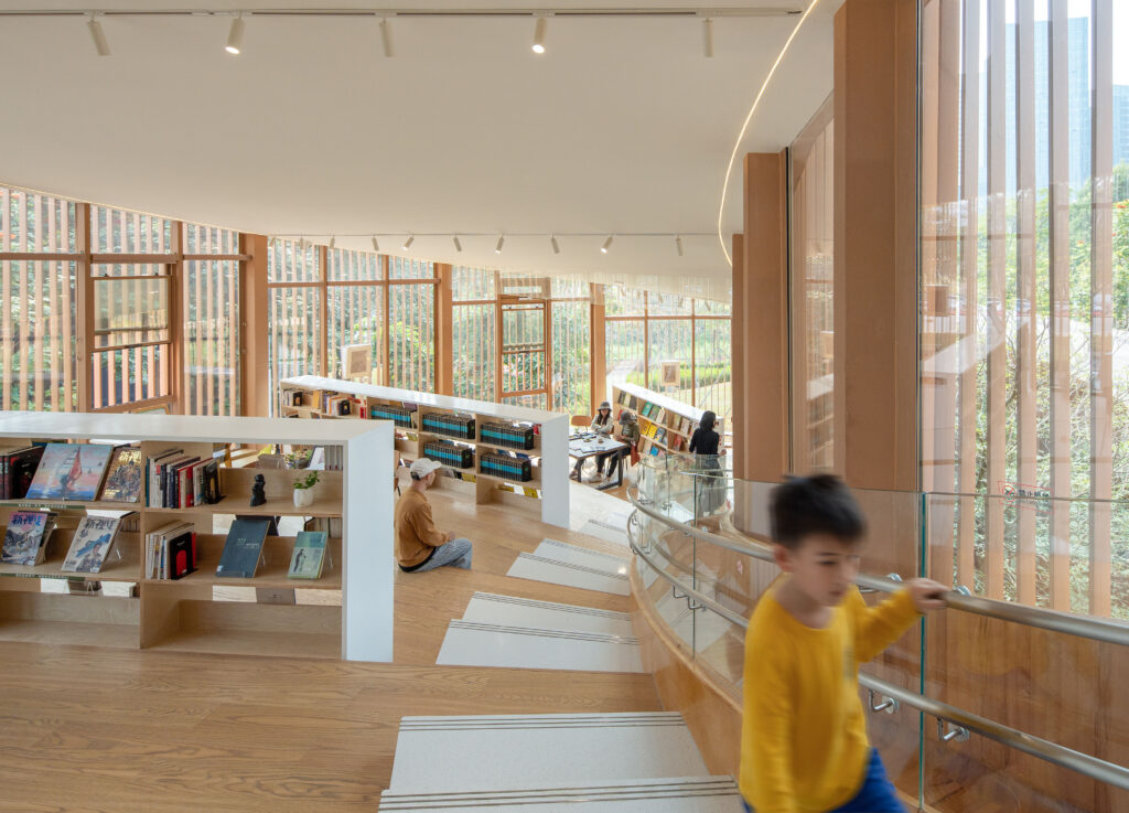 Interior view of the second-floor seating area showing the steel framework, oblique tension enforcement, and operable windows for natural ventilation