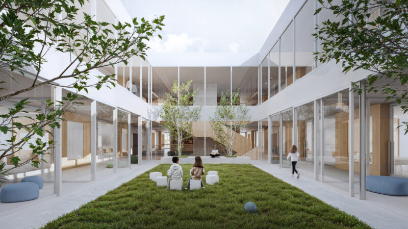 A rectangular outdoor patio at the core of the second floor, featuring a grassy lawn, small trees, and seating benches for relaxation