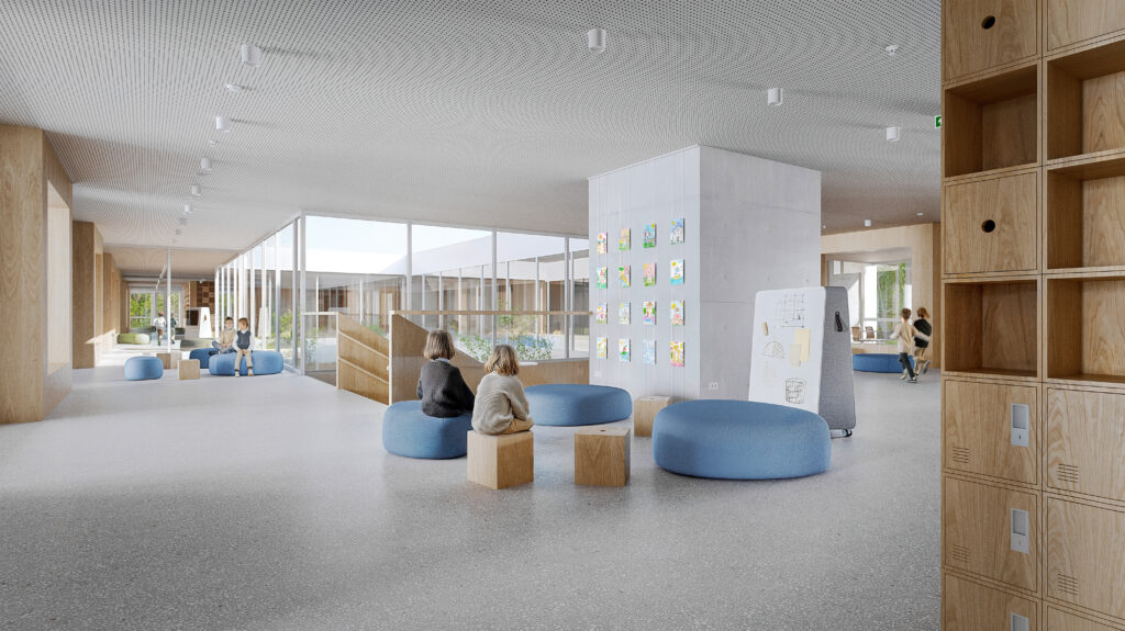 A fluid interior common zone showing blue seating pods and a concrete pillar used as a gallery for student artwork