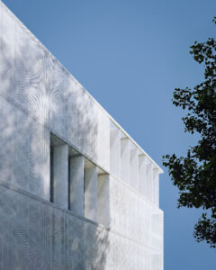 Close-up of the hinged metal mesh panels on the school’s facade that control natural light and heat throughout the year