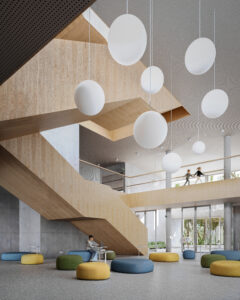 The central core of the school featuring a large wooden staircase, circular hanging lights, and colourful modular seating for students to gather