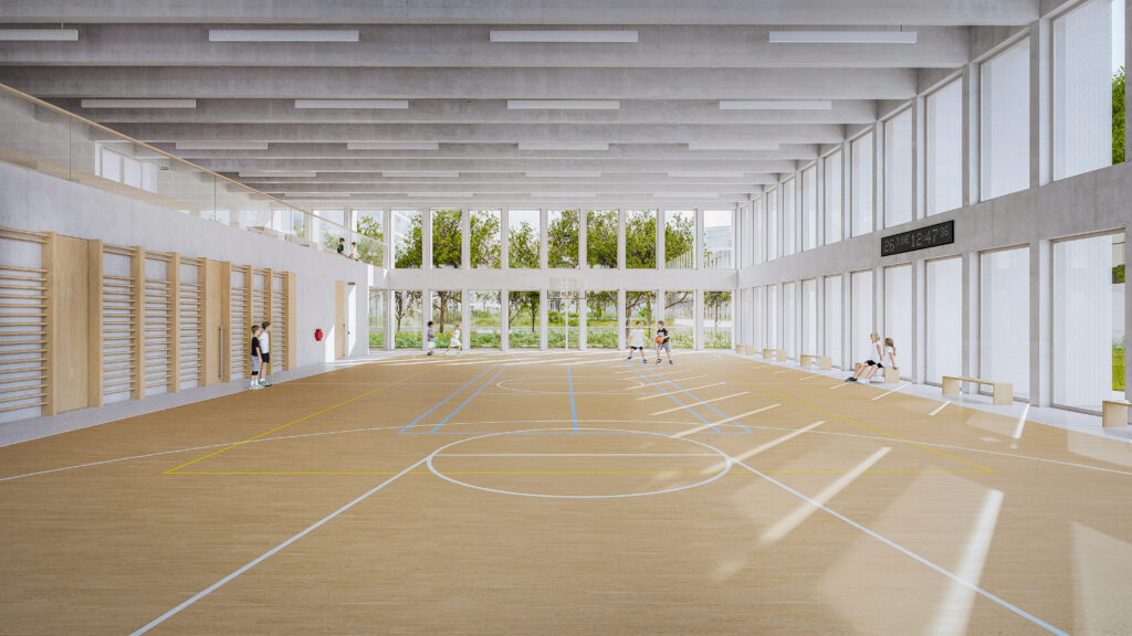 A large, bright indoor gym on the ground floor with wooden flooring, wall-mounted equipment, and large windows looking out to greenery
