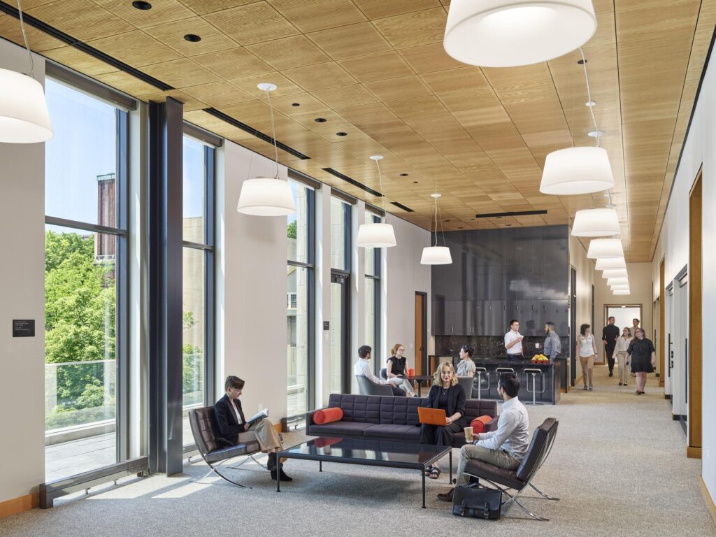 A third-floor lounge and networking space in the Vistex suite, featuring comfortable seating and a pantry area for receptions