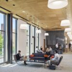 A third-floor lounge and networking space in the Vistex suite, featuring comfortable seating and a pantry area for receptions