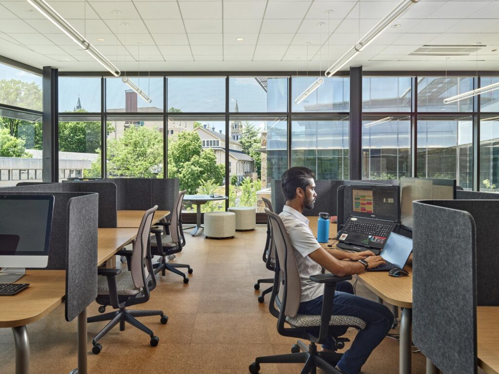 A specialized group-work pod located near the lobby, furnished with modern chairs and a low table for student collaboration