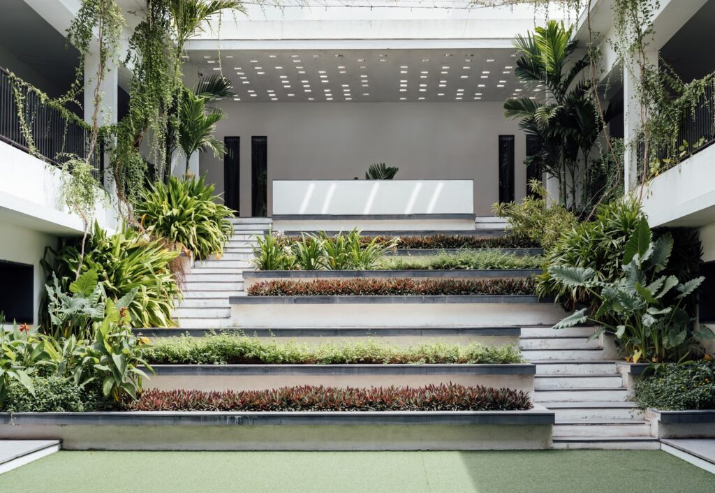 A view of the main central courtyard featuring terraced planters that serve as a vegetated gathering space