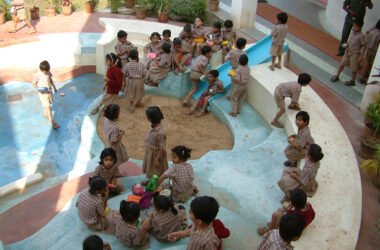 Overhead view of a circular, multi-level play area in the school courtyard featuring colourful china mosaic patterned flooring and slides