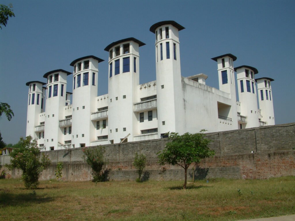 Exterior view of the tall white air inlet and exhaust shafts used for the Passive Downdraft Evaporative Cooling (PDEC) system