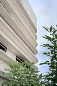 A detailed architectural shot of the white concrete fins that act as a brise-soleil to reduce heat generation on the classroom walls