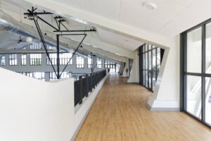 The upper floor gallery of the Vientiane International School sports facility, designed by EIW Architects to provide visual access to sporting areas and promote holistic development