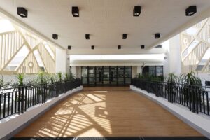 The transformative new gateway to VIS featuring a large timber-look logo screen that serves as a bold statement of identity and connects the school to its international and local context