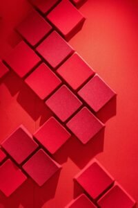 Detail of red diamond-shaped three-dimensional acoustic tiles used to influence sound performance at the Western Academy of Beijing.