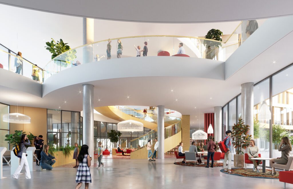 Bright, spacious interior render of the school's central double-height atrium lobby. The space is filled with columns, a sweeping curved mezzanine with a glass balustrade, students socializing, and tall glass windows showing the exterior courtyard.
