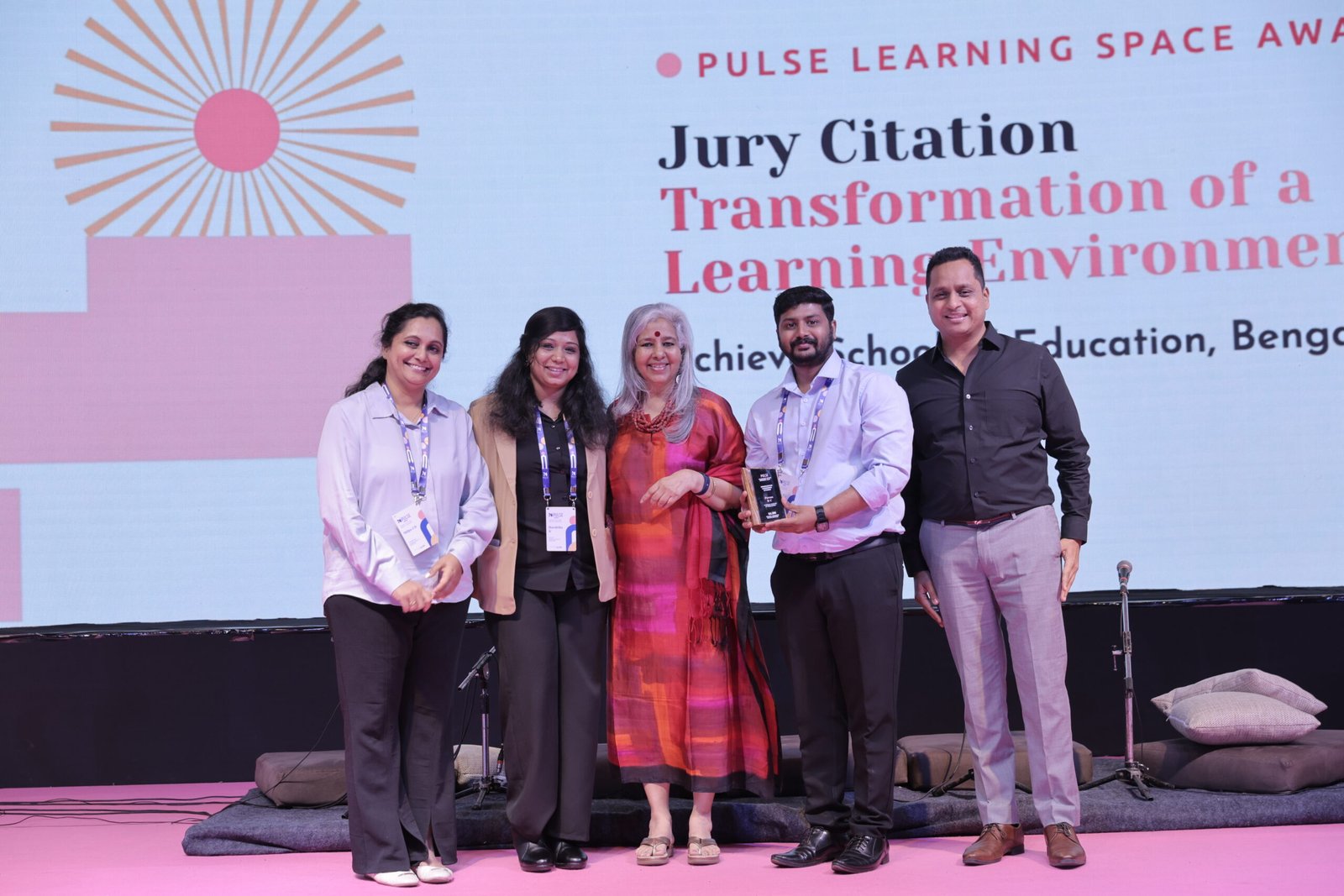 The Achieve School of Education team receiving the Transformation of a Learning Environment award on stage at the PULSE 2026 Gala